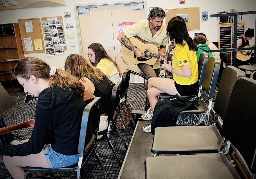 The newly added guitar class tunes up. Mr. Marcucci teaching students how to shred. 