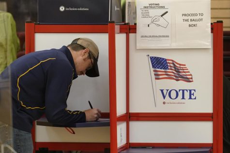 A Massachusetts man goes to the polls and casts his ballot in the 2022 primary.