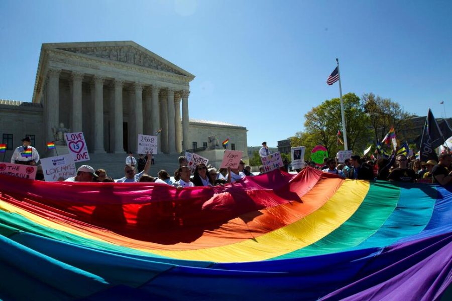 Protesters gather outside the Supreme Court prior to its decision on the legality of same-sex marriage in this landmark case.