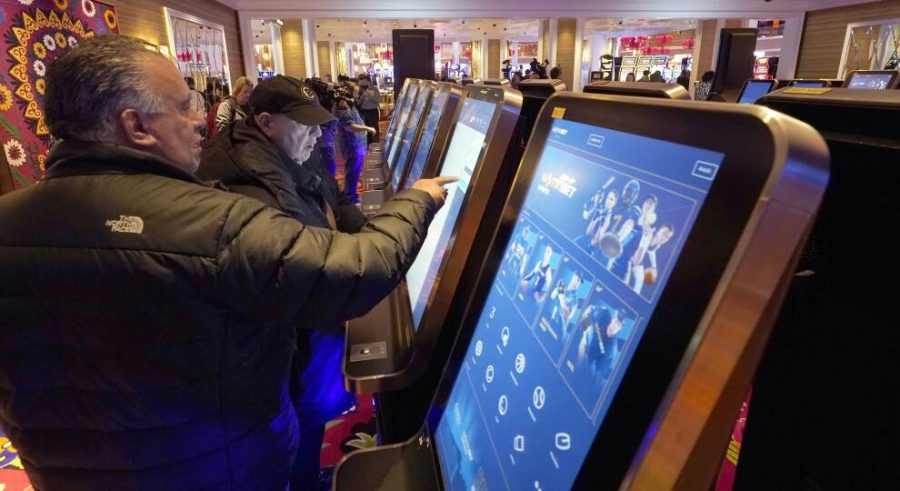 Sports enthusiast place their bets at Encore Boston Casino on the launch day of sports betting in Massachusetts.