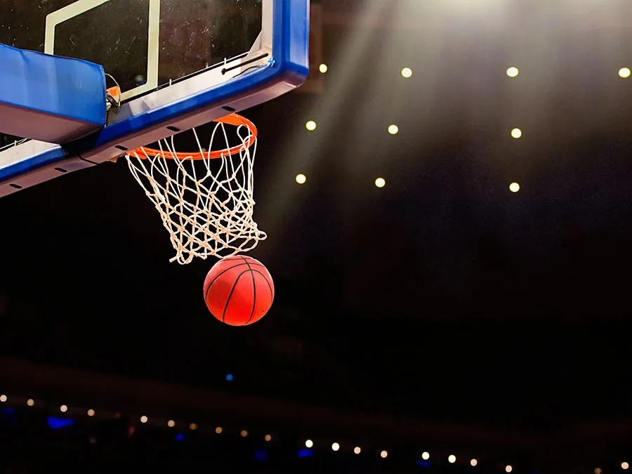 A basketball going through a net