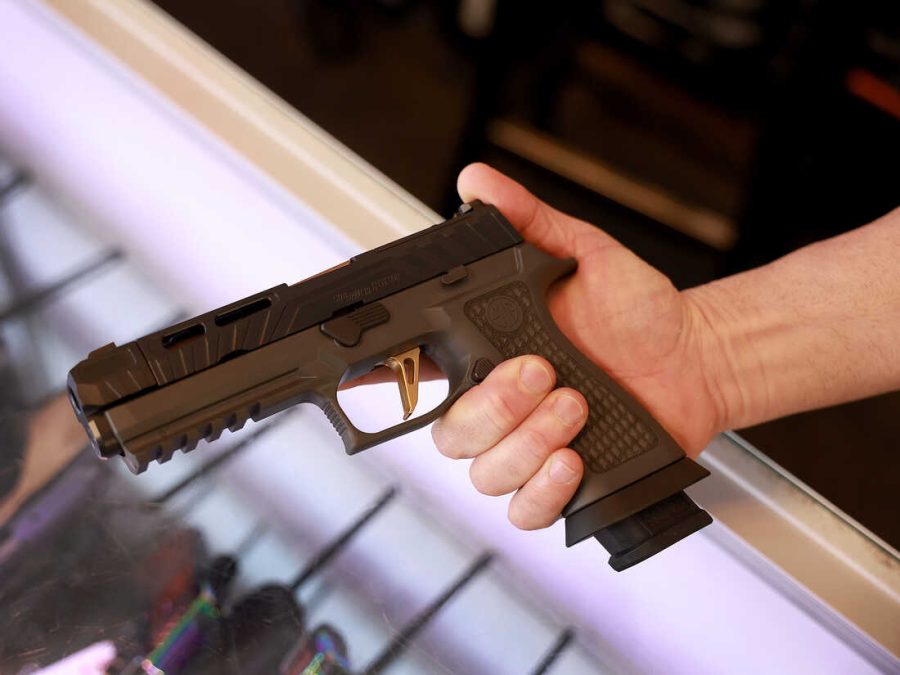 DELRAY BEACH, FLORIDA - JANUARY 31: A Sig Sauer P320 handgun is held at the WEX Gunworks store on January 31, 2023 in Delray Beach, Florida. The state of Florida may become the 26th state to allow people to carry concealed loaded guns without permits under legislation being considered in the Capitol. (Photo by Joe Raedle/Getty Images)