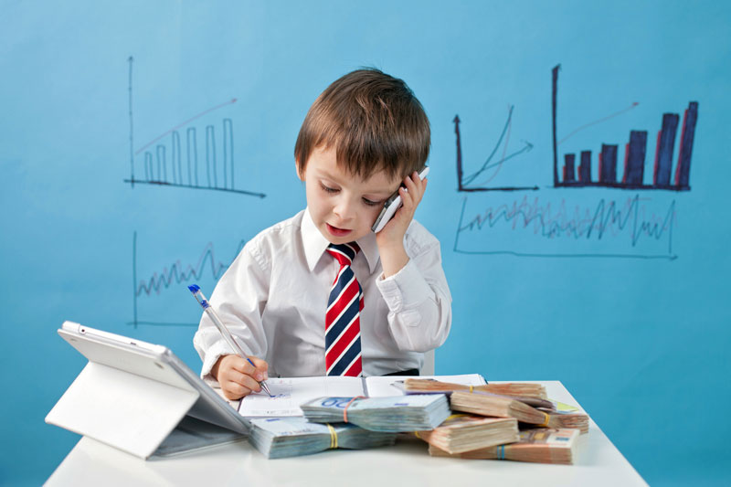 Young kid pretending to work on a business