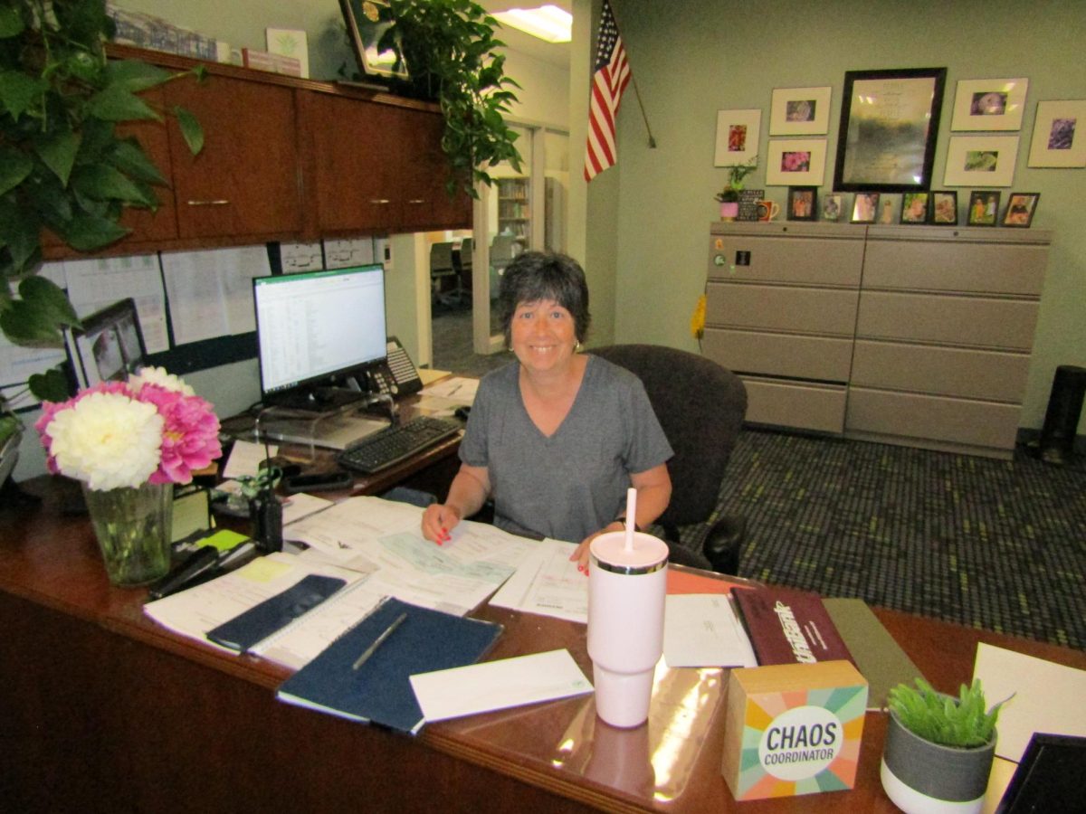 Mrs. Senecal keeps the high school running smoothly despite multiple tasks and interruptions. 