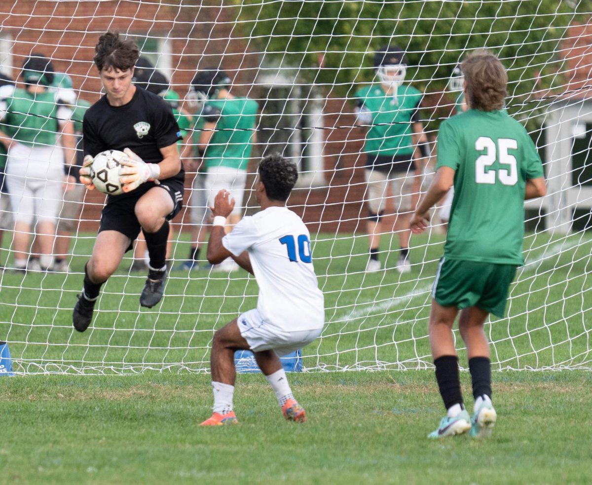 Boys varsity soccer goalkeeper, Isaac Bradley, makes a near goal-line save.