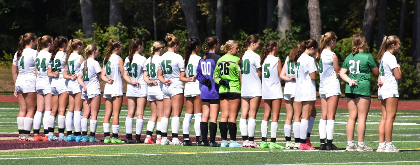 The Suzies stand together as a team on the field.