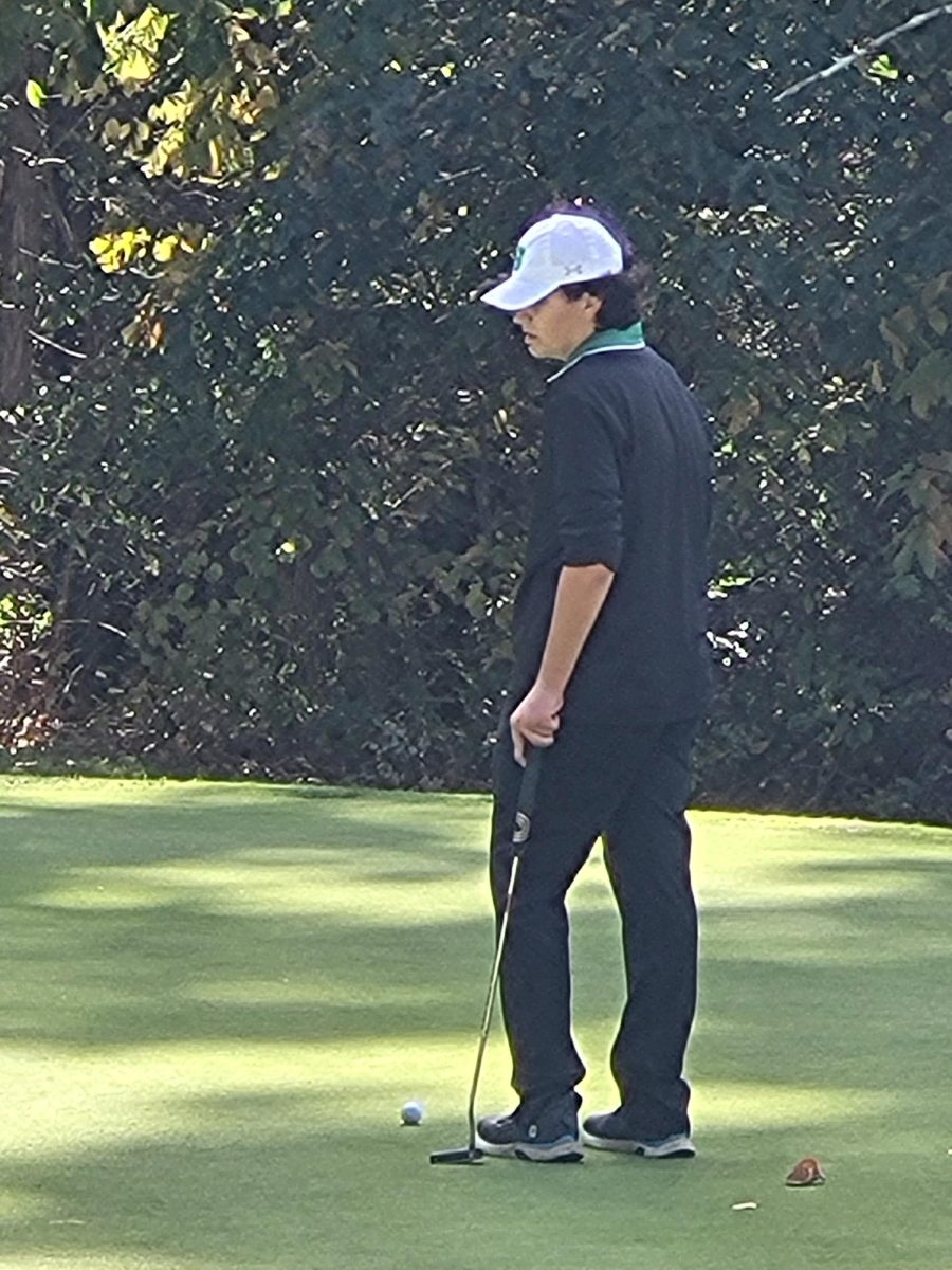 Troy Georgiopoulos gets the read on the green during yesterday's DVC championship