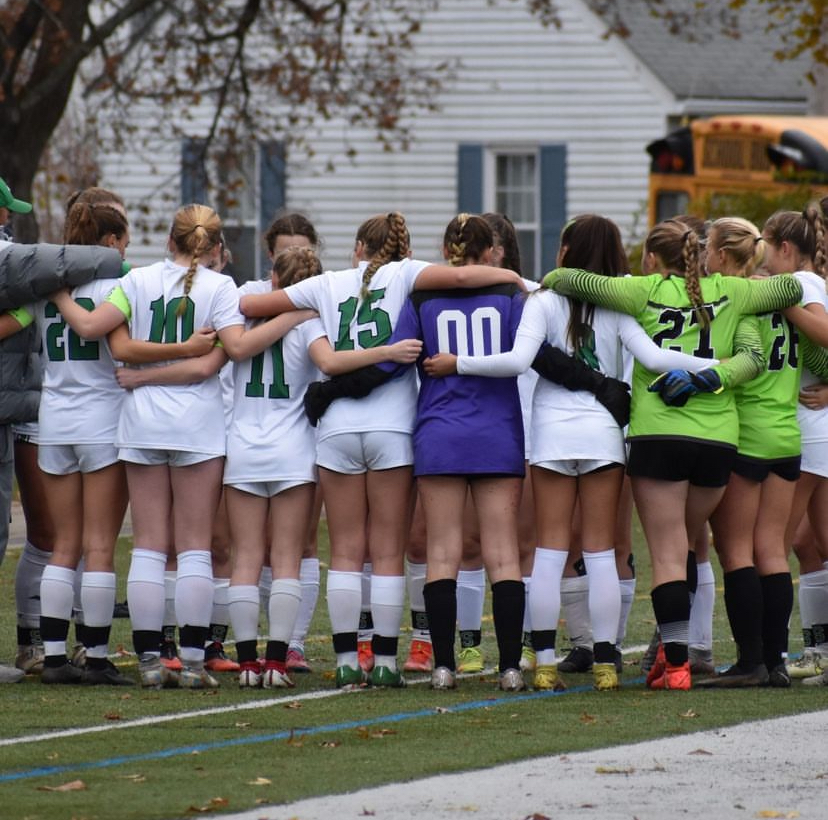 The varsity huddles before last year's MIAA Division 4 championship game.