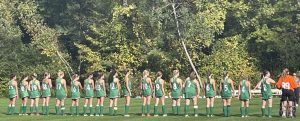 The Suzies field hockey team stands for the National Anthem before their game against Nipmuc.