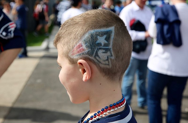 This young fan was ready for the game, but the Patriots lost to the Texans. (Voice of America)