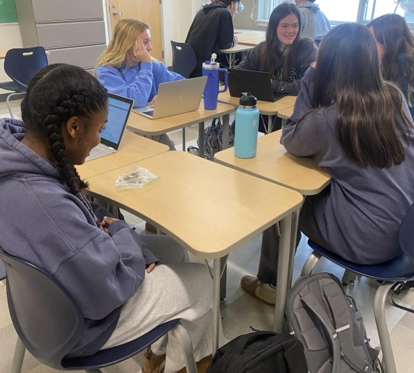 Student is sitting with friends getting persuaded to think a certain way (Addison Jerome)