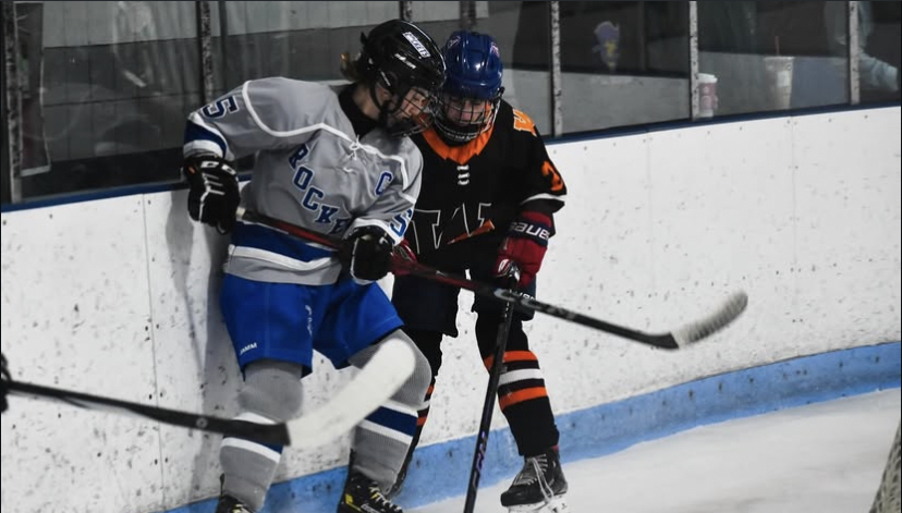 Leah Medeiros battles by the boards for a loose puck during a recent game (Kim Medeiros)