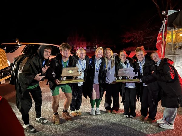 Sutton High School's soccer seniors hold up their state champ trophies after the win.