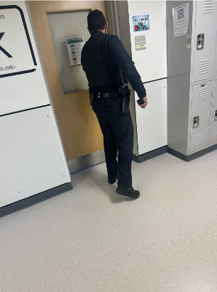 The School Officer Checking If The Lock Down Protocol Is Being Followed.