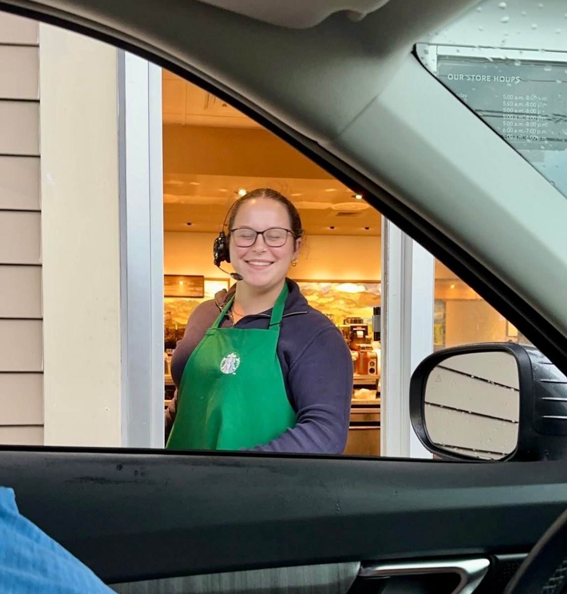 Seven teen year old working at her part time job at Starbucks.