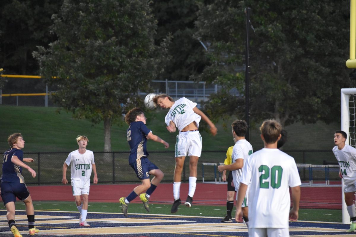 Chase Gara plays a ball near the goal during a soccer game.