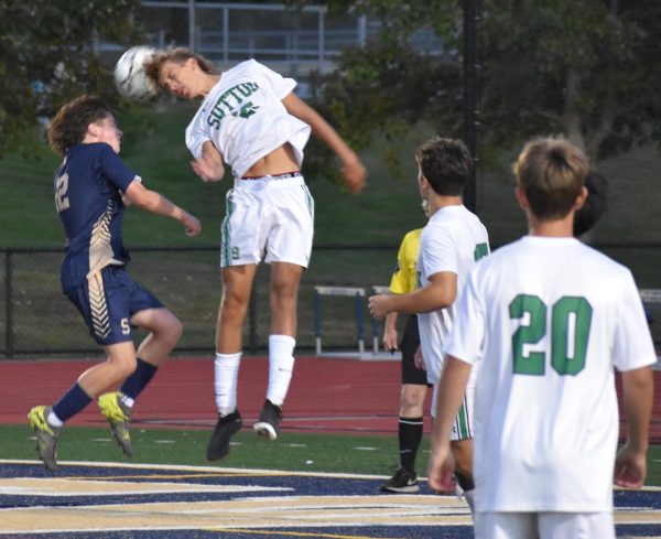 Chase Gara plays a ball near the goal during a soccer game.