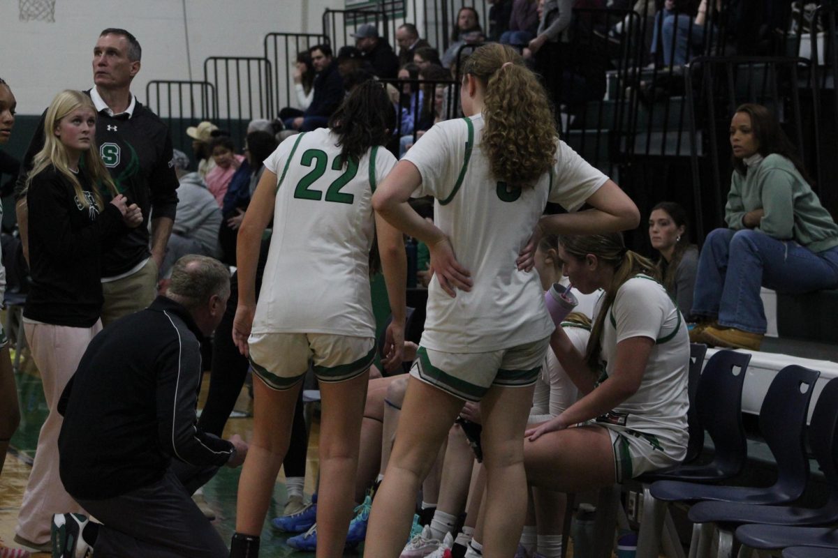 Coach Craig Mahoney goes over strategy with his team in recent action