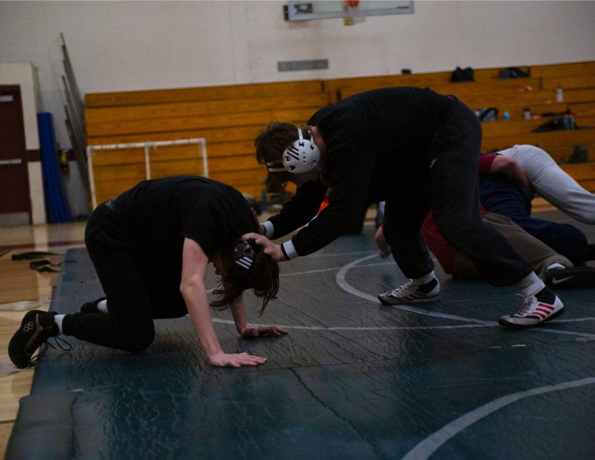 Two Northbridge wrestlers practice while wearing appropriate headgear