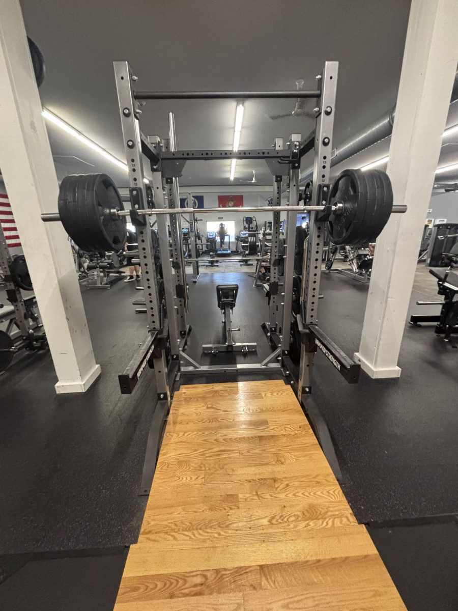 A barbell on the squat rack bending from heavy weight